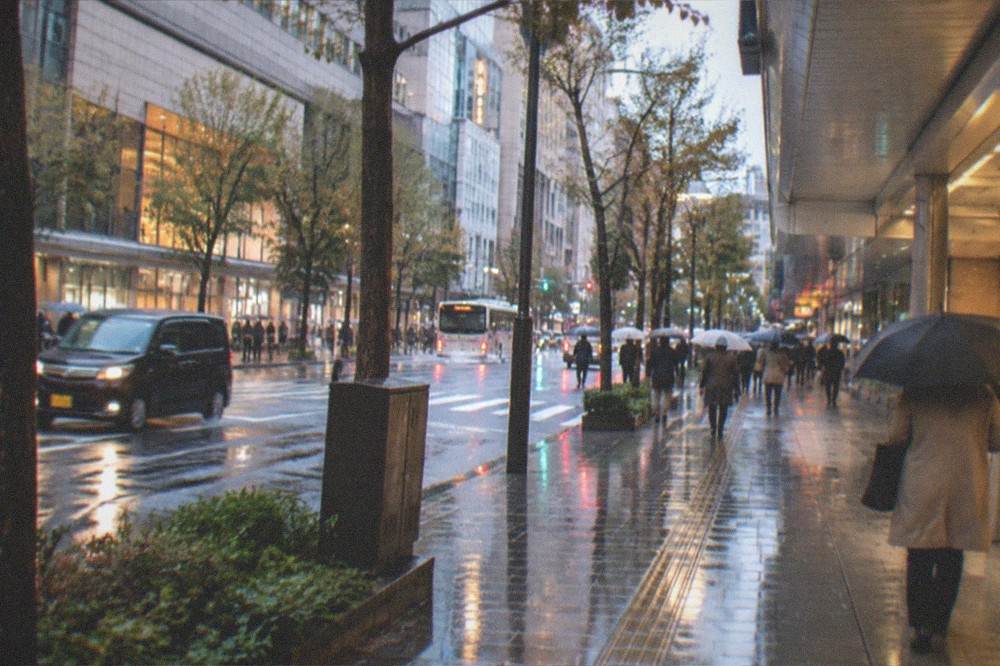 Rain-wet street in the Tenjin district reflecting shop lights after evening rain