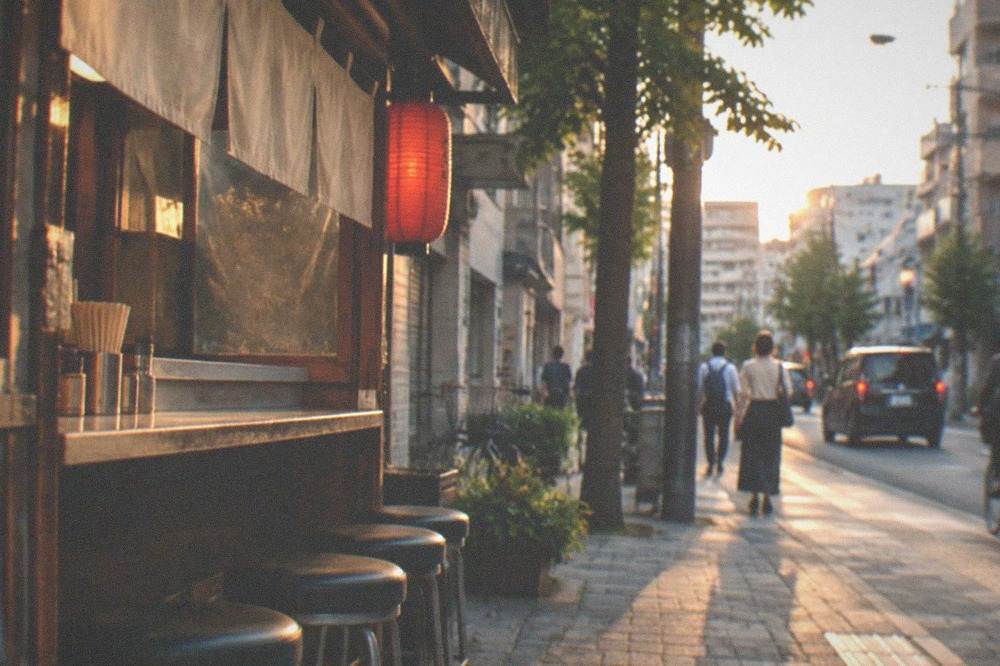 Empty bench seats at a small food stall counter waiting for evening customers