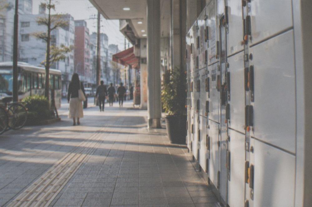 Rows of coin lockers along a bright station corridor