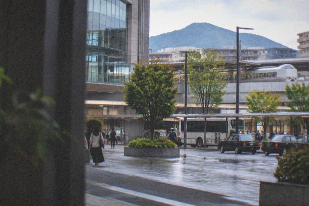 A limited express train at a platform with mountains in the distance