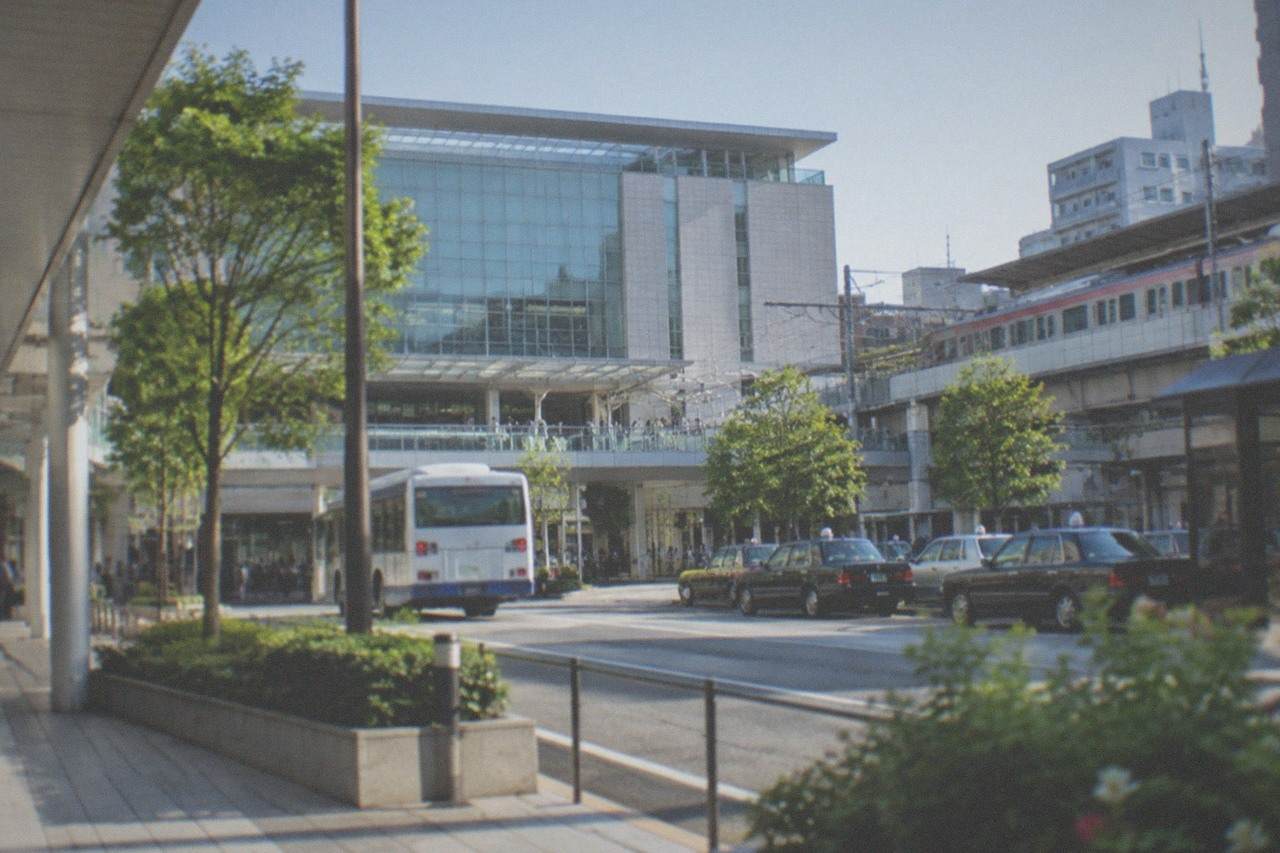 A limited express train standing at a station platform in Fukuoka under a clear morning sky