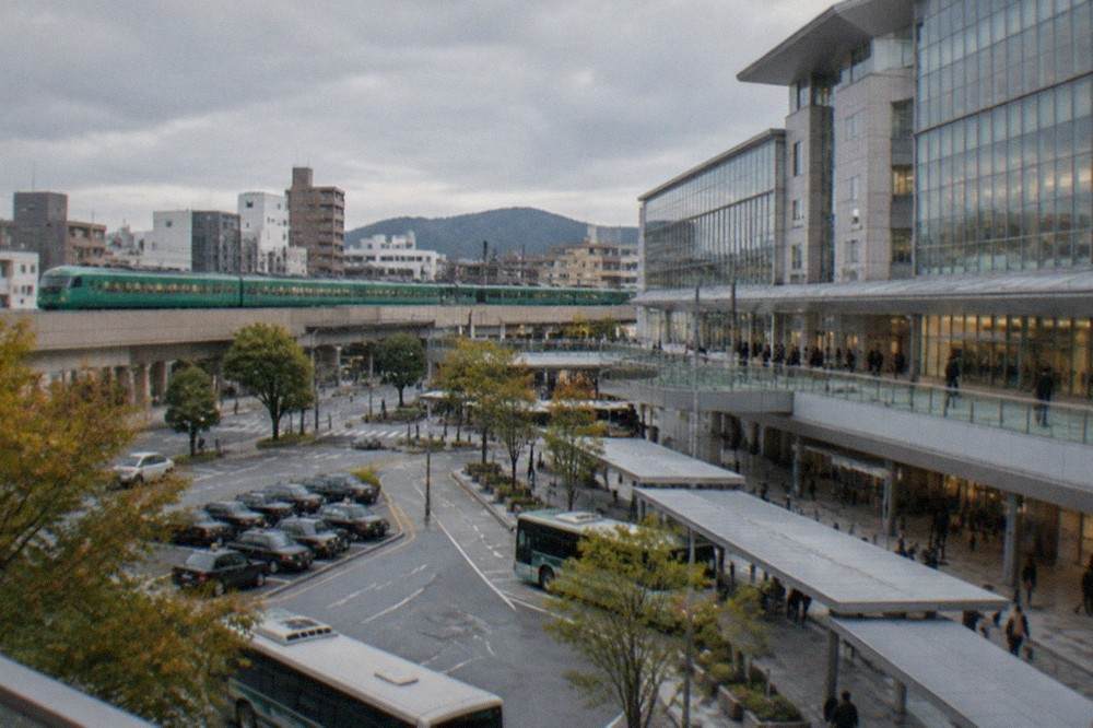A green JR limited express train at a rural Kyushu platform