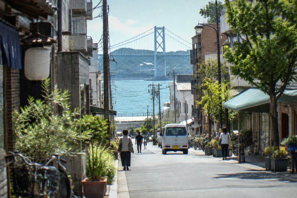 Narrow strait crossing with a suspension bridge over green water