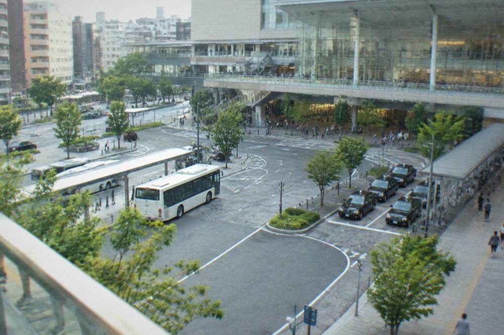 A wide airport terminal concourse with departure boards and moving walkways