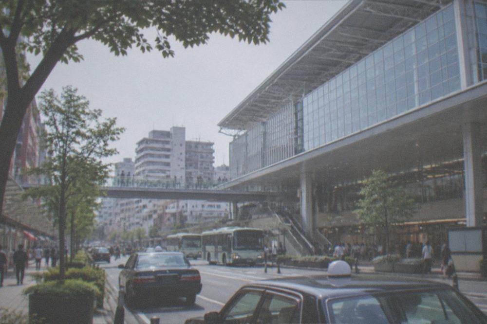 A subway platform with a train at Fukuoka Airport station