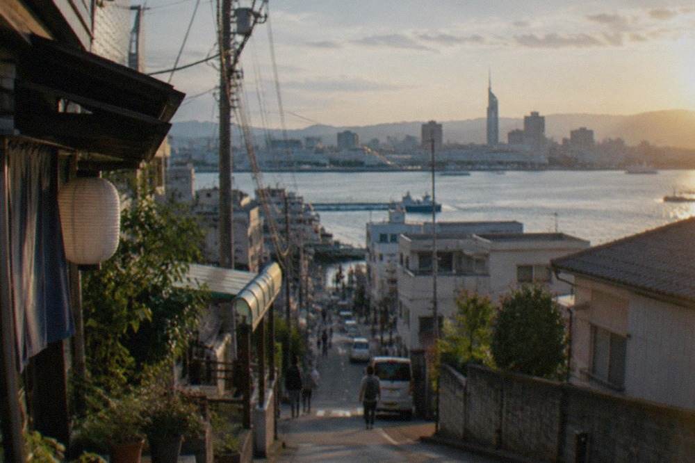 Fukuoka city skyline across Hakata Bay with tall buildings and a calm harbour in the foreground
