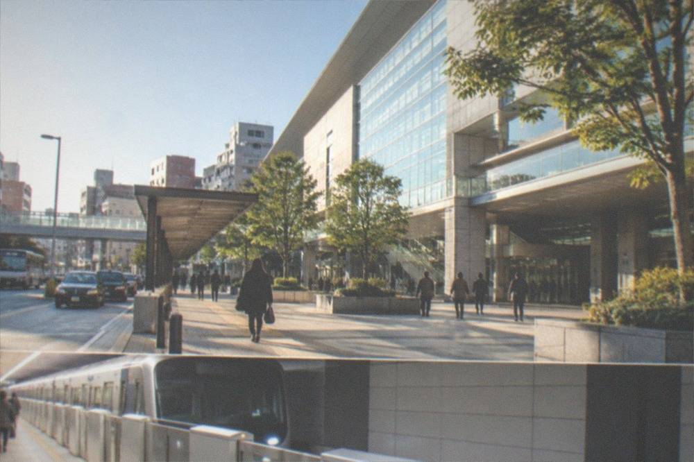 Modern subway platform in Fukuoka with a train arriving and platform screen doors
