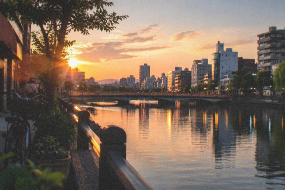 Naka River at twilight with illuminated bridges and city skyline reflections