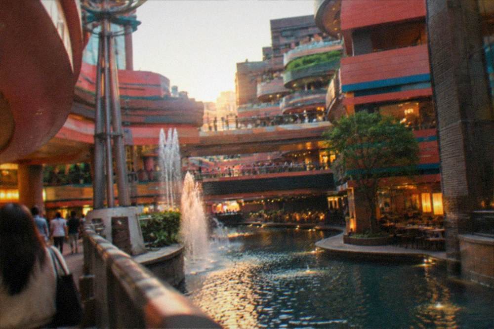 Canal City Hakata's indoor canal with fountain and surrounding shops in evening light