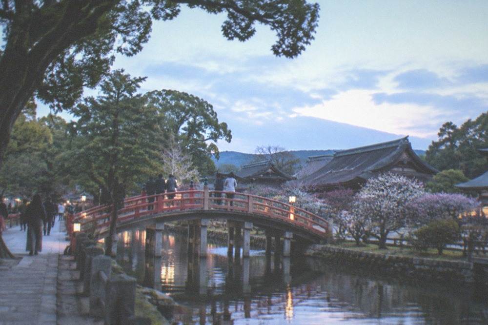 Taiko bridge over a pond leading to the shrine buildings at Dazaifu Tenmangu