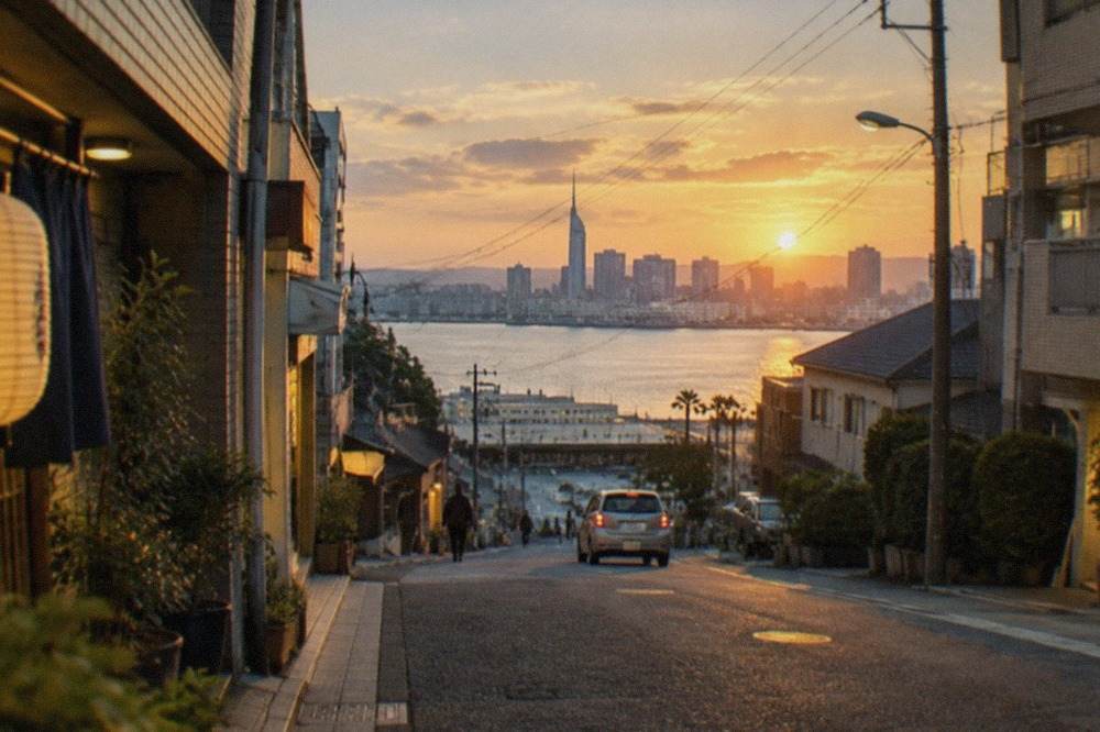 Fukuoka city skyline across Hakata Bay at dusk with illuminated waterfront buildings