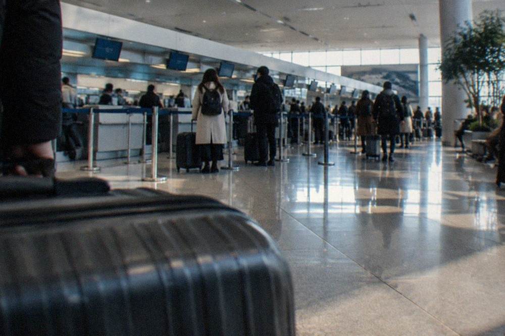 The departure hall of Fukuoka Airport with check-in counters and signage