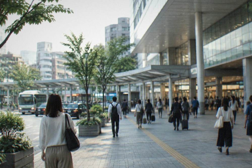 The concourse of Hakata Station with travellers walking beneath departure boards
