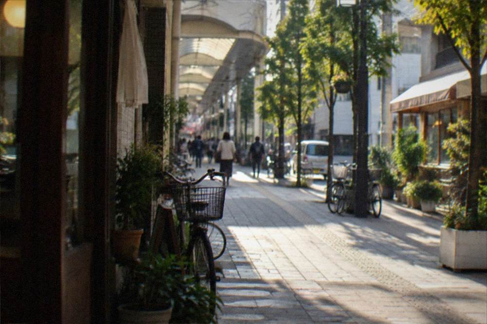 A narrow shopping arcade lit by warm signage on an evening in a Japanese city